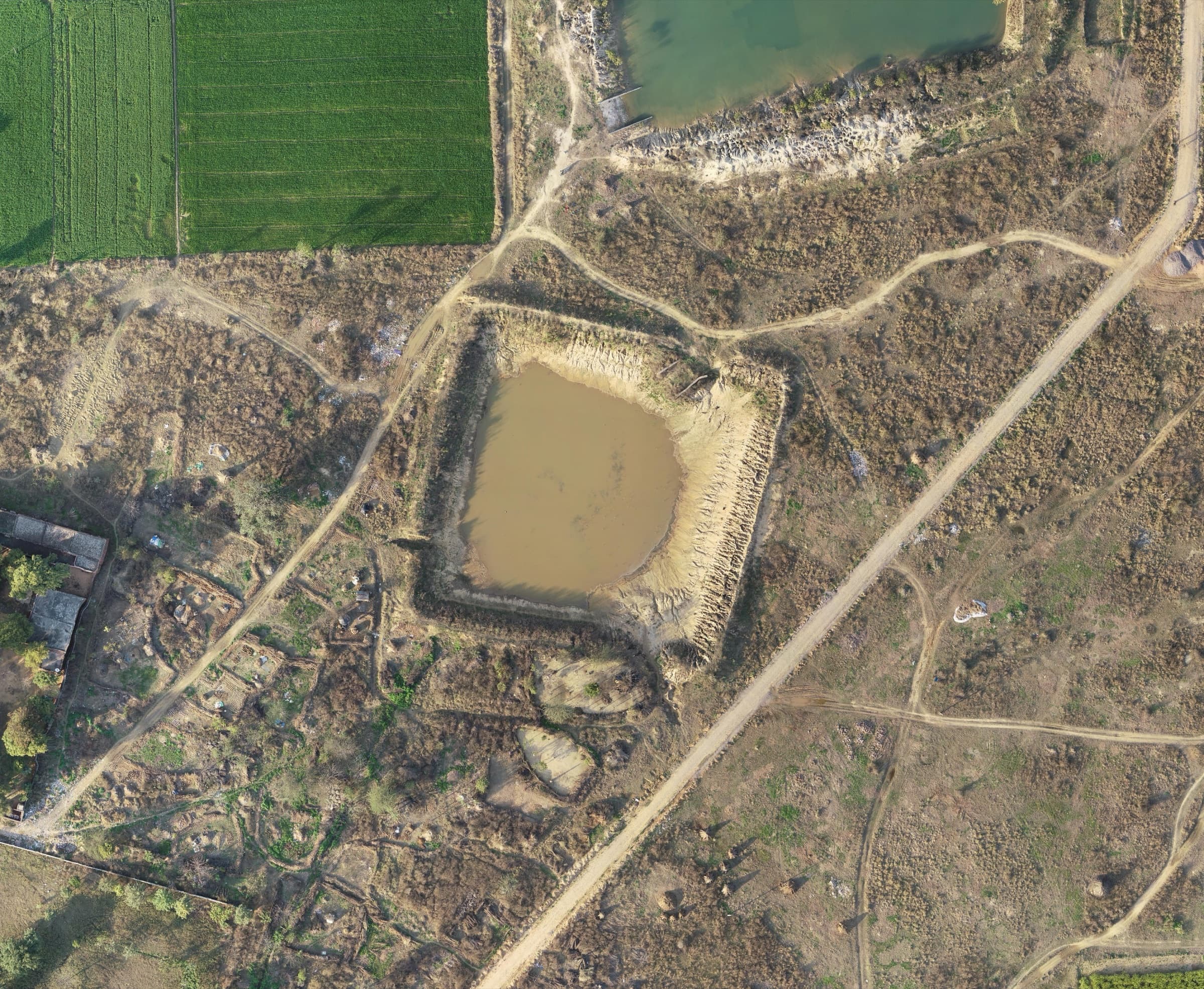 Triveni Pond before completion — dewatered, desilted pond bed under construction