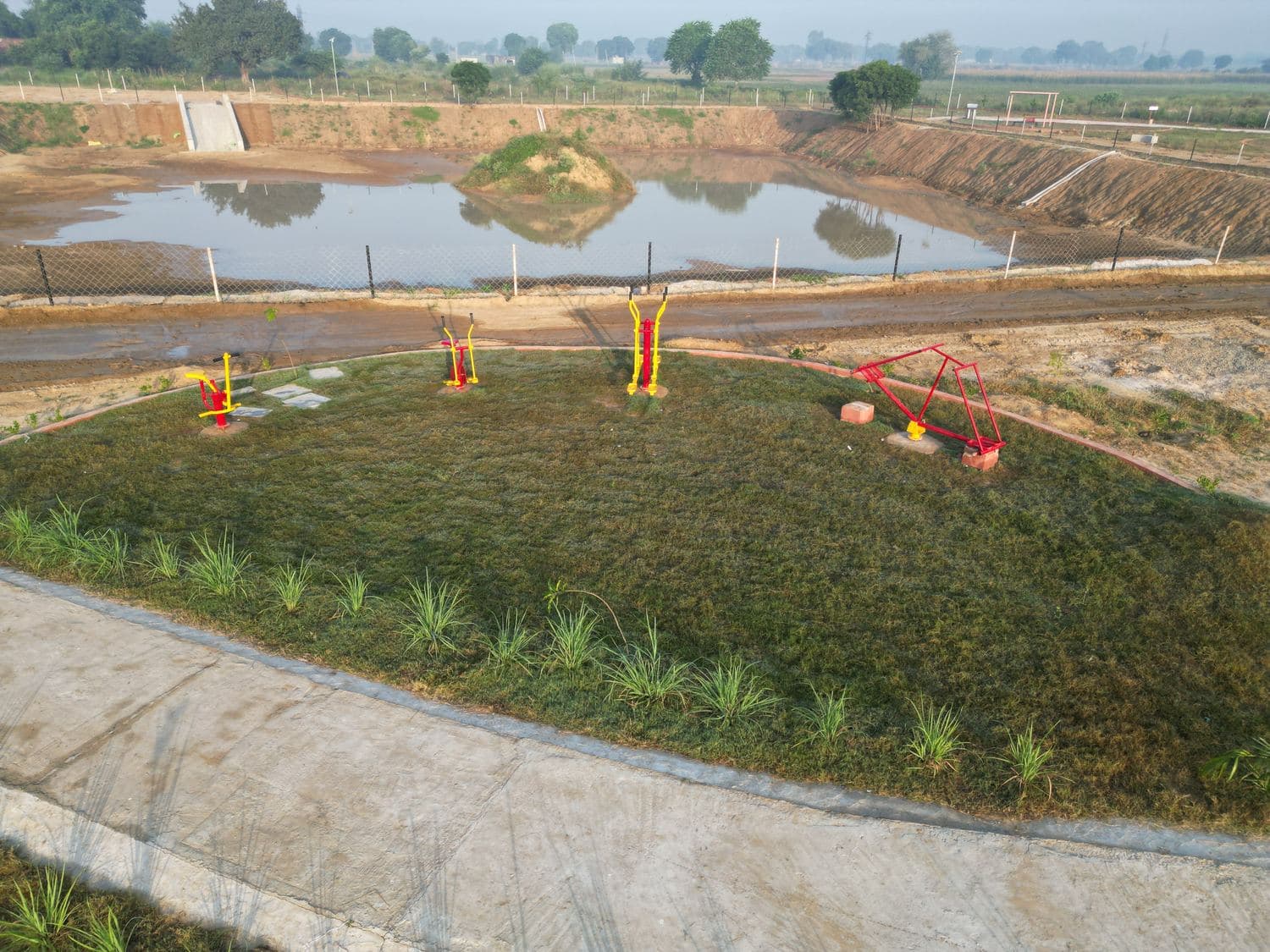 The landscaped pond edge with reed beds and play equipment