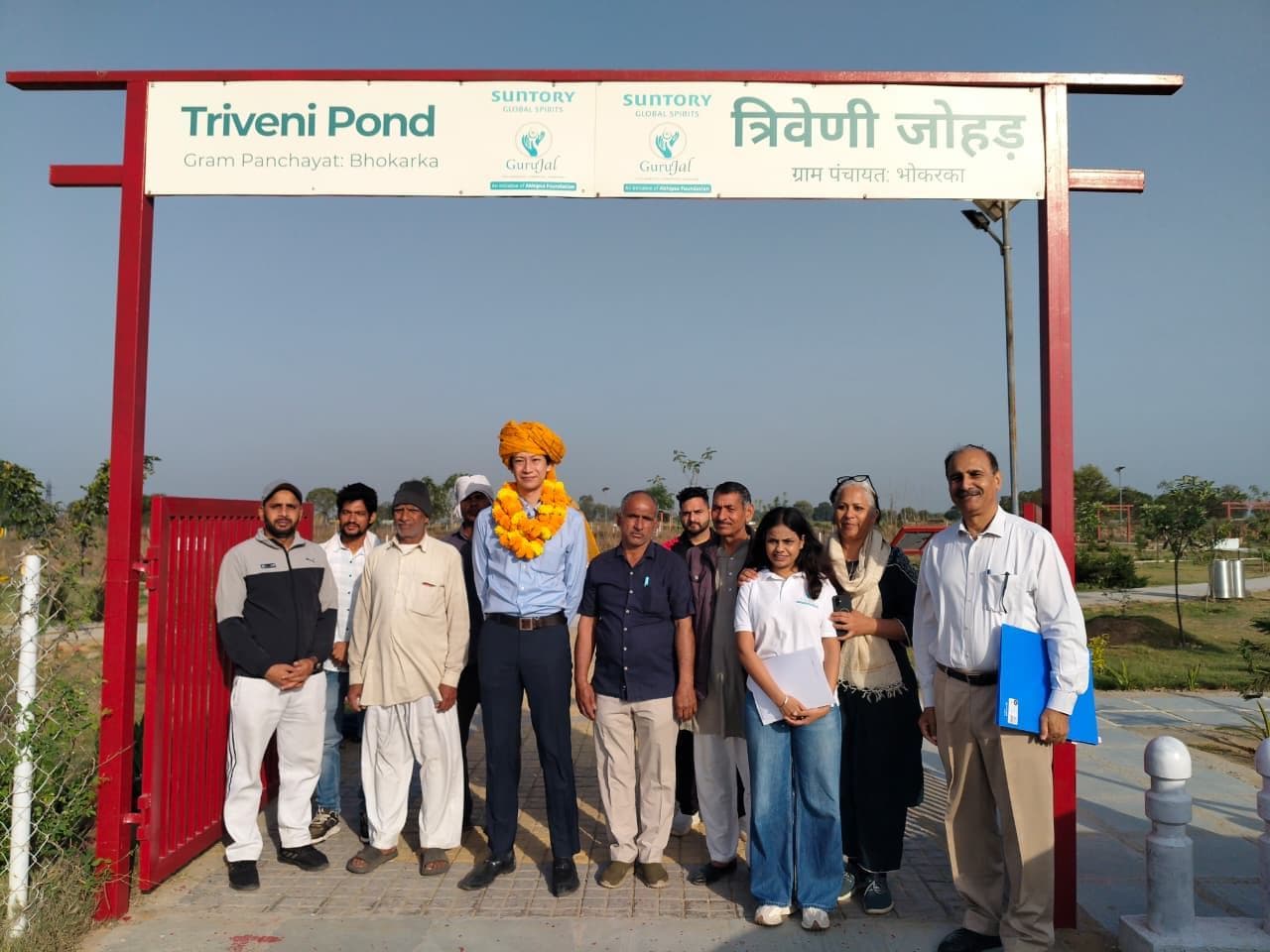 GuruJal and Suntory Global Spirits team with community members at the Triveni Pond gateway